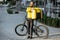 Courier portrait with bicycle and bag outdoors