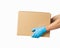 Courier presents cardboard box in rubber gloves