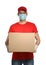 Courier in protective mask and gloves holding cardboard box on background. Delivery service during coronavirus quarantine
