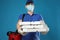 Courier in protective mask and gloves holding pizza boxes on background. Food delivery service during quarantine