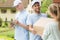 Couriers in blue uniforms and caps giving package to a customer