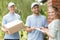 Couriers and content woman signing a form