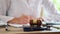 Court gavel with stethoscope on a table in background doctor writes notes