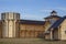 Courtyard of an ancient reconstructed wooden fortress with high walls and a bell tower