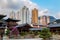 Courtyard and buildings of Chi Lin Nunnery in Nan Lian Gardens, Hong Kong. Background of city skyline, clouds and blue sky.