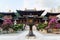 Courtyard and buildings of Chi Lin Nunnery in Nan Lian Gardens, Hong Kong. Background of city skyline, hills and clouds.