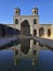 Courtyard of Nasir al Molk mosque. Pink Mosque is reflected in the pool.