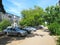 Courtyard of the road , cars , trees, and houses in the city