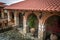 Courtyard with terracotta and stonework tiling and plants in pots. Meteora, Kalabaka, Greece.