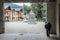 Courtyard of the tourist town of Mestia in the Svaneti region with a cow in the arch and a sculpture of Swan on a horse in the bac