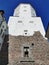 The courtyard of the Vyborg Castle and the entrance to the St. Olaf Tower in the city of Vyborg against the blue sky