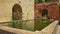 Courtyards and gardens featuring lush vegetation and peaceful water ponds with koi fish at the Real Alcazar, Seville, Spain