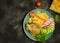 Cous cous with chicken and vegetables and greens on a black background near Eastern pita bread