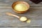 Couscous in a clay bowl and wooden spoon