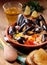 Couscous with mussels in earthenware bowl