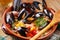 Couscous with mussels in earthenware bowl