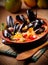 Couscous with mussels in earthenware bowl