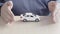 Cover the Toy Car With your Hands. Male Hands of an Insurance Agent Protecting a Small Toy Car. The Concept of