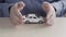 Cover the Toy Car With your Hands. Male Hands of an Insurance Agent Protecting a Small Toy Car. The Concept of