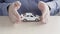 Cover the Toy Car With your Hands. Male Hands of an Insurance Agent Protecting a Small Toy Car. The Concept of