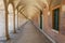 Covered arcade of royal palace at Aranjuez behind fence, Spain