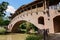 Covered arch bridge across river in sunny autumn