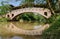 Covered arch bridge over river in sunny autumn