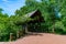 Covered Bridge Entrance with Trees along the Naperville Riverwalk over the DuPage River