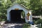 Covered Bridge in the woods made of wood and painted white