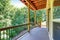 Covered deck with railings and forest landscape