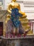 Covered lady placing candles at temple