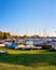 Covered sailing boats ashore with harbor in the background