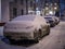 Covered with snow parked car in winter