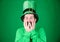 Covering his face with hands with delight. Happy Irish man with beard wearing green. Hipster in leprechaun hat and