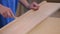 Covering irregularities on a wooden board. Correction of defects in a wooden board.