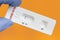 Covid-19 antigen test kit on orange background. Negative diagnosis of Covid-19 with the rapid antigen test kit. Quick text of