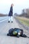 COVID-19. A black gas mask and a backpack lie on the side of an asphalt highway