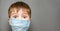 Covid 19 child vaccination, banner. Amazed kid surprised boy wearing mask child shocked eyes wide open. Open eyes