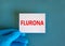 Covid-19 corona and flu flurona symbol. Hand in blue glove with white card. The concept word Flurona. Stethoscope. Medical and