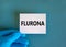 Covid-19 corona and flu flurona symbol. Hand in blue glove with white card. The concept word Flurona. Stethoscope. Medical and