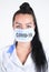 Covid-19 coronavirus desease global pandemic outbreak. A young female doctor in a medical mask with lettering.