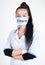 Covid-19 coronavirus desease global pandemic outbreak. A young female doctor in a medical mask with lettering. Close up portrait f