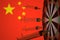 COVID-19 coronavirus disease vaccine syringes hit target against the Chinese flag. Successful research and vaccination