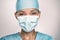 COVID-19 Coronavirus pandemic happy Asian doctor positive with hope wearing surgical mask and blue protective scrubs at