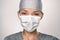 COVID-19 Coronavirus pandemic happy Asian doctor positive with hope wearing surgical mask and blue protective scrubs at