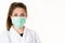 COVID-19 Coronavirus pandemic woman doctor wearing protective surgical mask at hospital