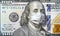 COVID-19 coronavirus in USA, 100 dollar money bill with face mask. Coronavirus affects global stock market