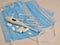 COVID-19 epidemic,blue disposable medical masks,thermometer,pills and medical ampoules glass on a white background.Coronavirus