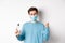 Covid-19, health and quarantine concept. Cheerful man in face mask celebrating, showing fist pump and bottle with hand