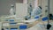 Covid-19 hospital ward with doctors in safety suits and coronavirus patients. Coronavirus pandemic, covid-19 concept.